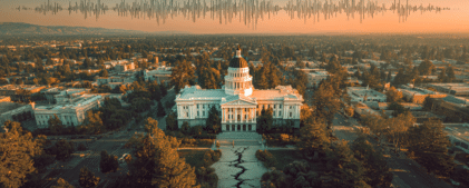 Aerial view of a government building with a large ground crack in front and an earthquake waveform graphic overlaying the sky at sunset.